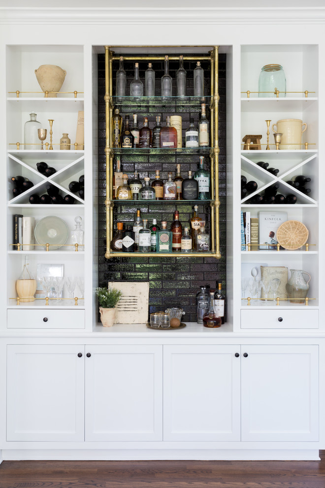 Inspiration for a beach style single-wall home bar in Los Angeles with no sink, open cabinets, white cabinets, black splashback, dark hardwood floors, brown floor and white benchtop.