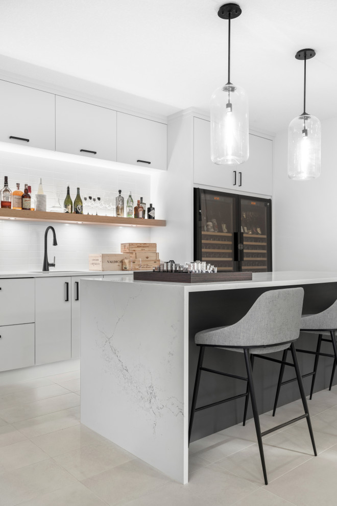 Photo of a medium sized modern galley wet bar in Calgary with a submerged sink, flat-panel cabinets, grey cabinets, engineered stone countertops, white splashback, ceramic splashback, porcelain flooring, grey floors and white worktops.