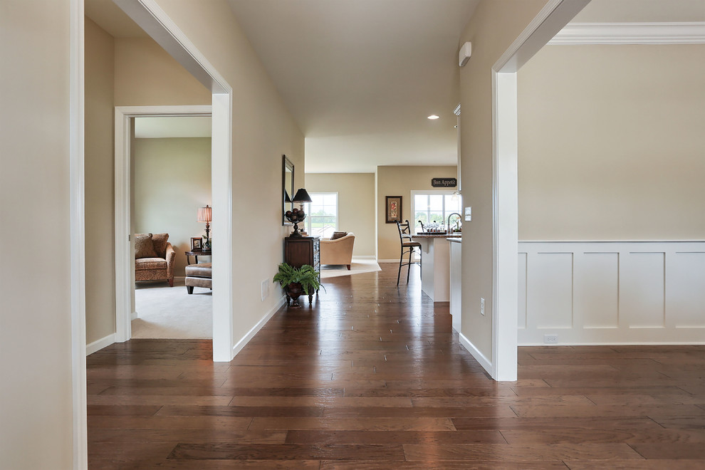 Photo of a large traditional hallway in Other with beige walls and medium hardwood floors.