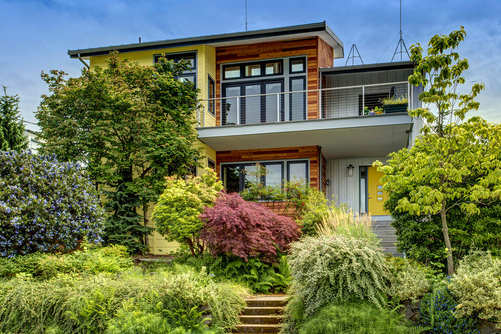 Large contemporary two-storey yellow exterior in Seattle.