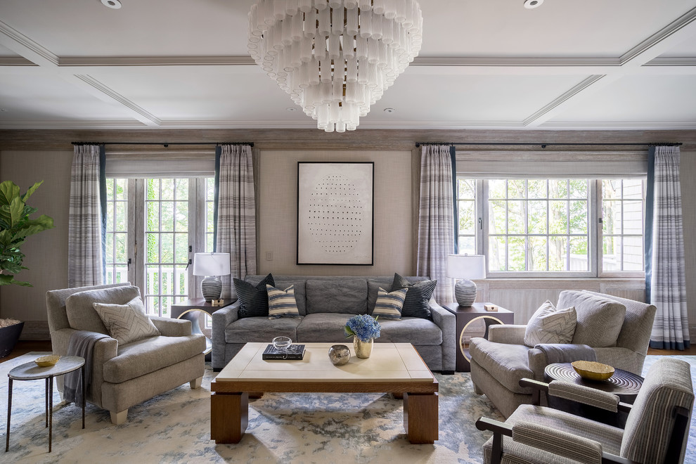 This is an example of a transitional living room in New York with grey walls and medium hardwood floors.
