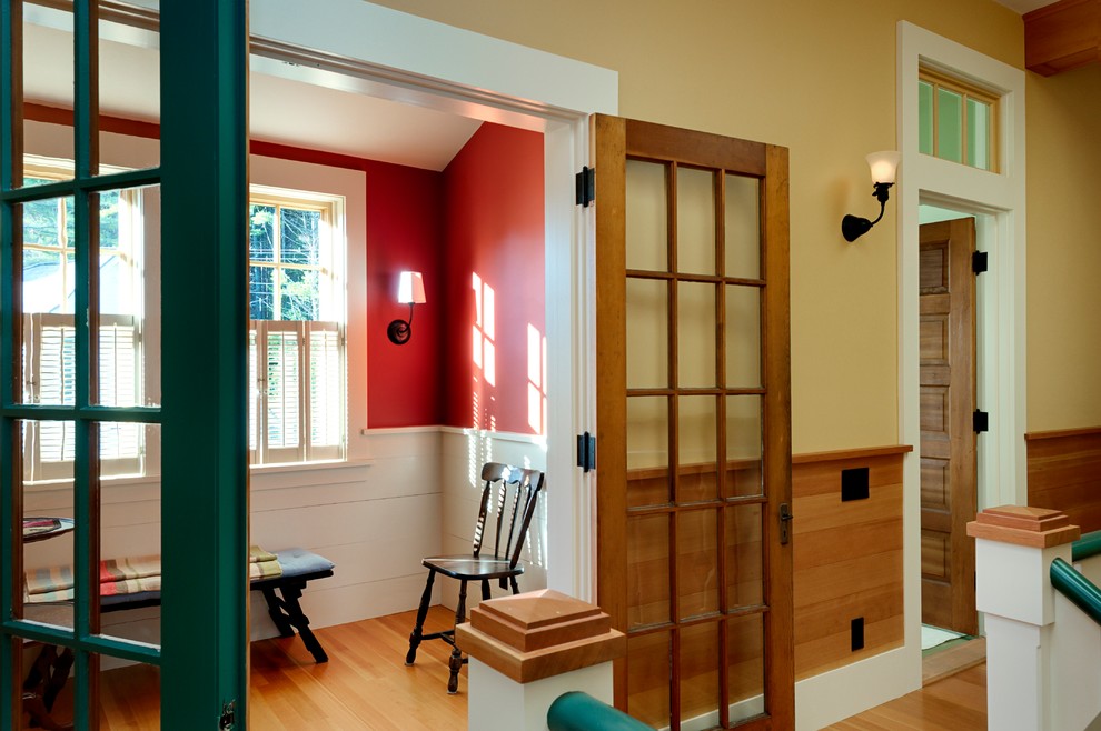 Design ideas for a country home office in Burlington with red walls and medium hardwood floors.