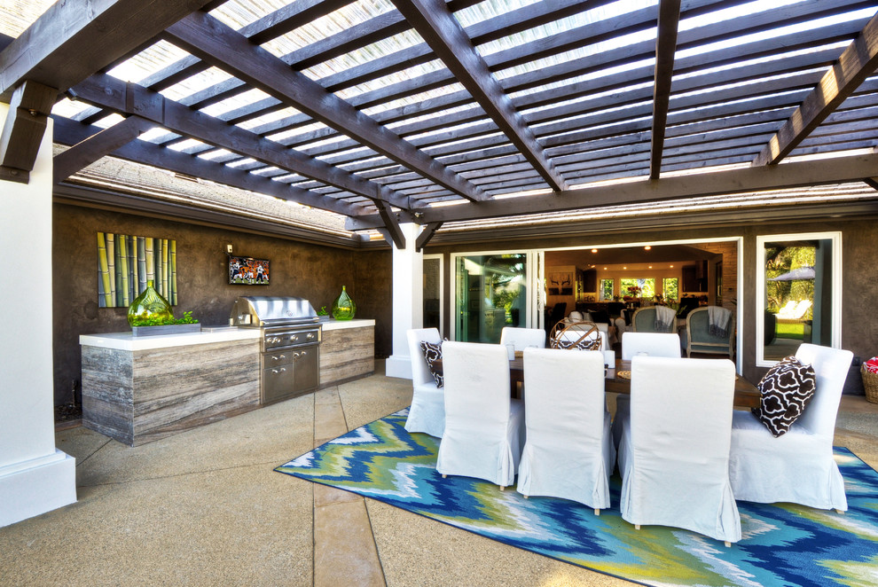 Photo of a large transitional backyard patio in Orange County with an outdoor kitchen, decomposed granite and a pergola.