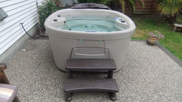 Inspiration for a backyard gravel and round aboveground hot tub remodel