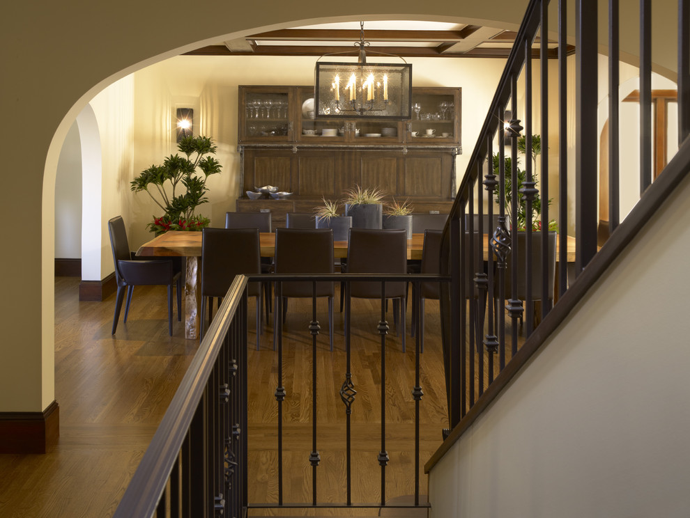 This is an example of a traditional dining room in San Francisco with beige walls and dark hardwood floors.