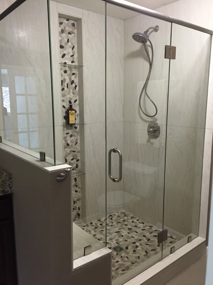 Corner shower - transitional master gray tile, multicolored tile and porcelain tile mosaic tile floor corner shower idea in Denver with a hinged shower door