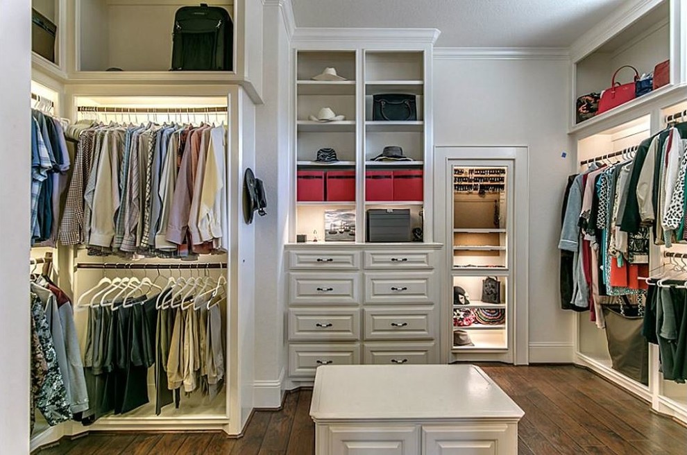Design ideas for a large mediterranean gender-neutral dressing room in Houston with flat-panel cabinets, white cabinets and dark hardwood floors.