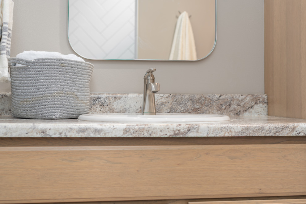 Bathroom - transitional master vinyl floor, white floor and double-sink bathroom idea with shaker cabinets, light wood cabinets, a two-piece toilet, gray walls, a drop-in sink, laminate countertops, gray countertops and a built-in vanity
