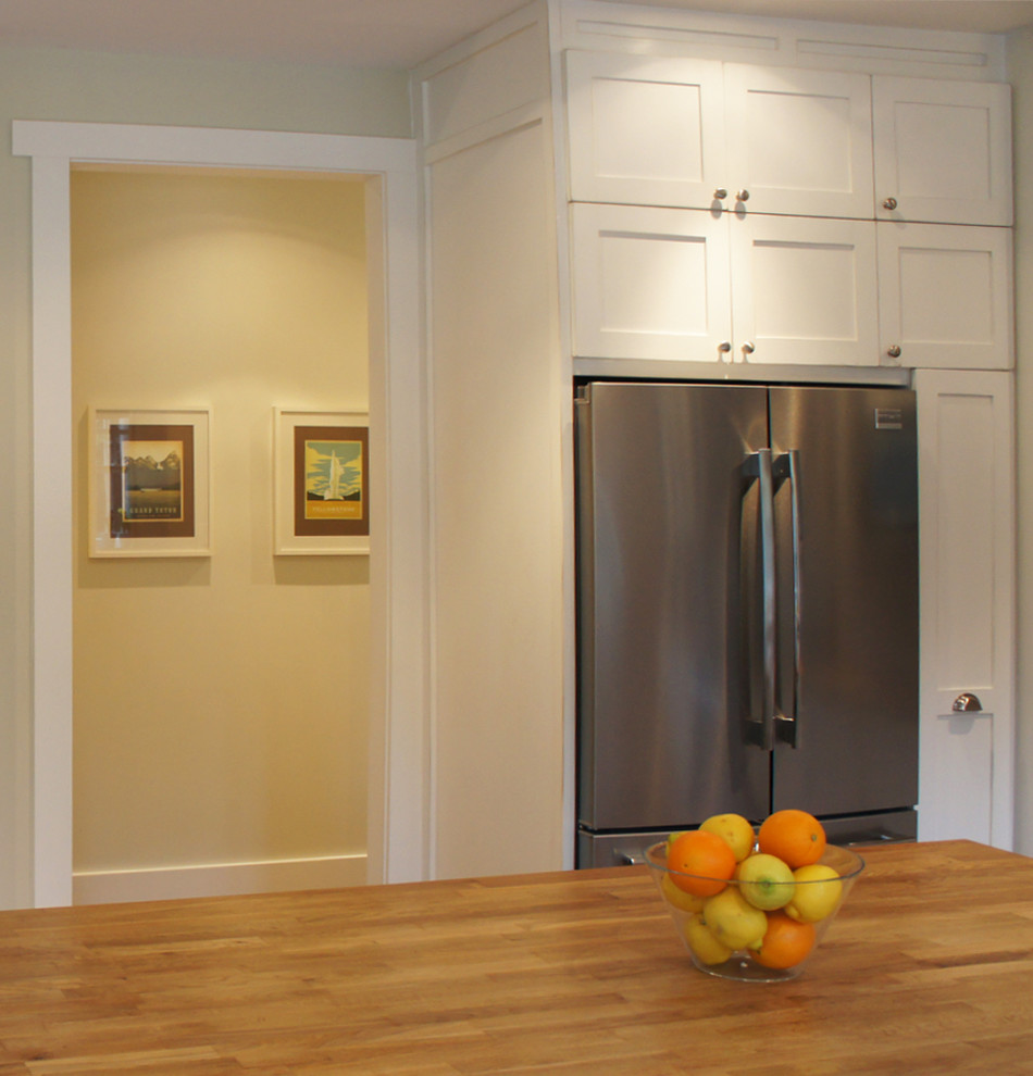 Example of a large transitional u-shaped medium tone wood floor open concept kitchen design in Ottawa with a farmhouse sink, shaker cabinets, distressed cabinets, wood countertops, white backsplash, subway tile backsplash, stainless steel appliances and an island
