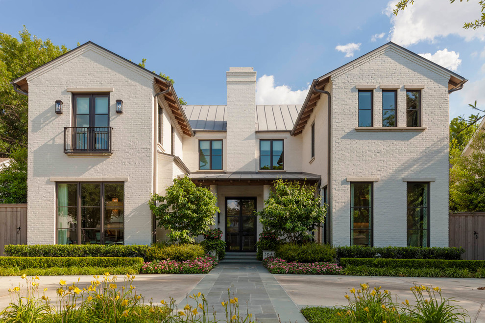 Inspiration for a mid-sized transitional two-storey brick white exterior in Dallas with a gable roof.