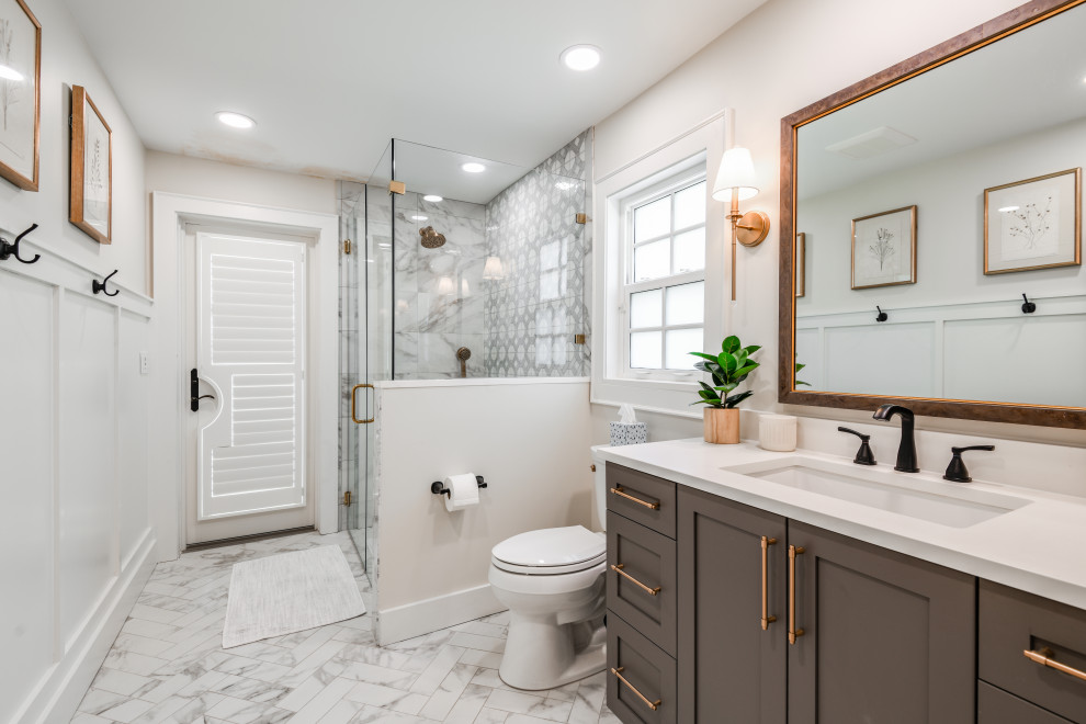 Design ideas for a medium sized classic shower room bathroom in Tampa with recessed-panel cabinets, dark wood cabinets, a double shower, grey tiles, marble tiles, marble flooring, a submerged sink, engineered stone worktops, a hinged door, white worktops, a single sink, a built in vanity unit and wainscoting.
