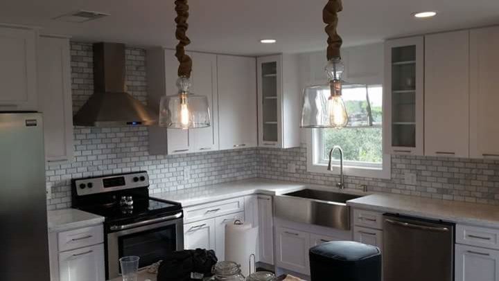 Example of a kitchen design in Miami with stone tile backsplash