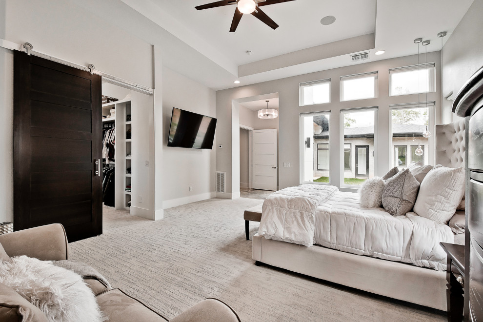 This is an example of an expansive modern master bedroom in Other.