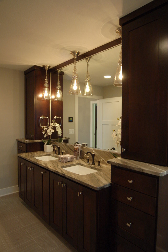 Example of a mid-sized transitional master gray tile and porcelain tile porcelain tile freestanding bathtub design with an undermount sink, furniture-like cabinets, dark wood cabinets, quartzite countertops, a two-piece toilet and gray walls