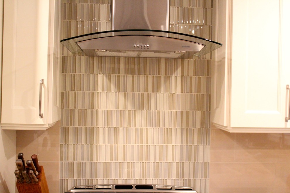 Inspiration for a mid-sized transitional u-shaped porcelain tile and brown floor eat-in kitchen remodel in DC Metro with an undermount sink, recessed-panel cabinets, white cabinets, granite countertops, beige backsplash, porcelain backsplash, stainless steel appliances and an island