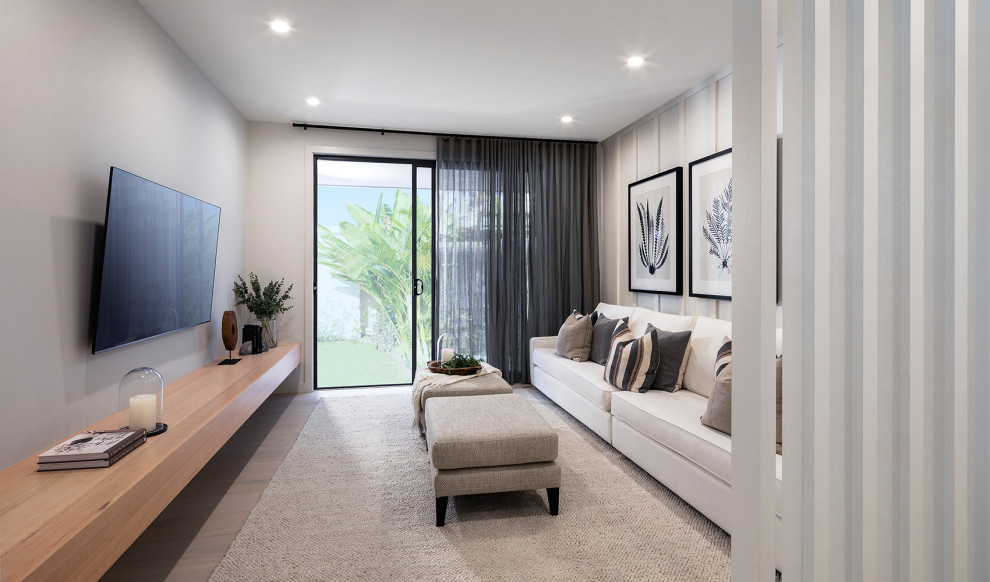 Mid-sized contemporary enclosed living room in Other with grey walls, a wall-mounted tv and grey floor.