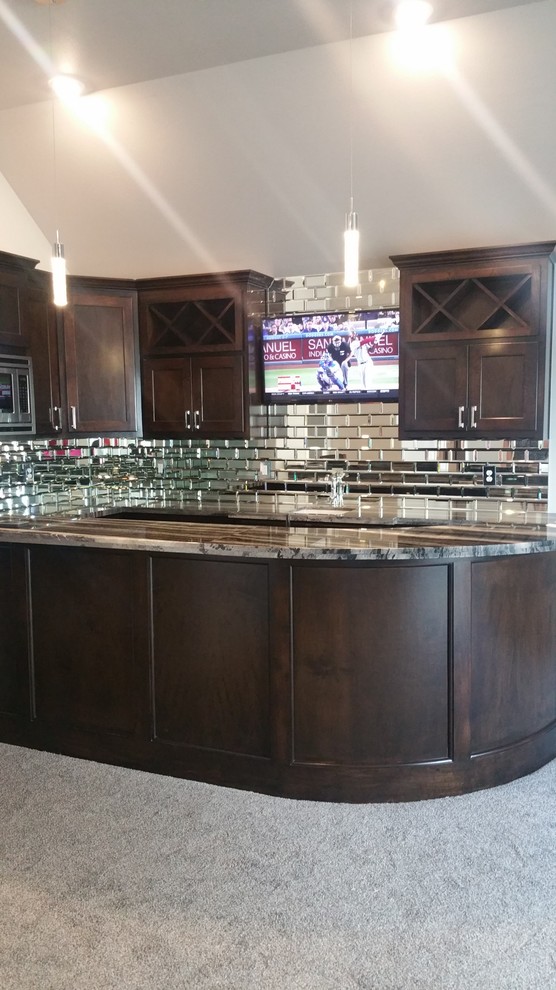 Inspiration for a large transitional l-shaped wet bar in Other with an undermount sink, shaker cabinets, dark wood cabinets, granite benchtops, carpet, mirror splashback and grey floor.