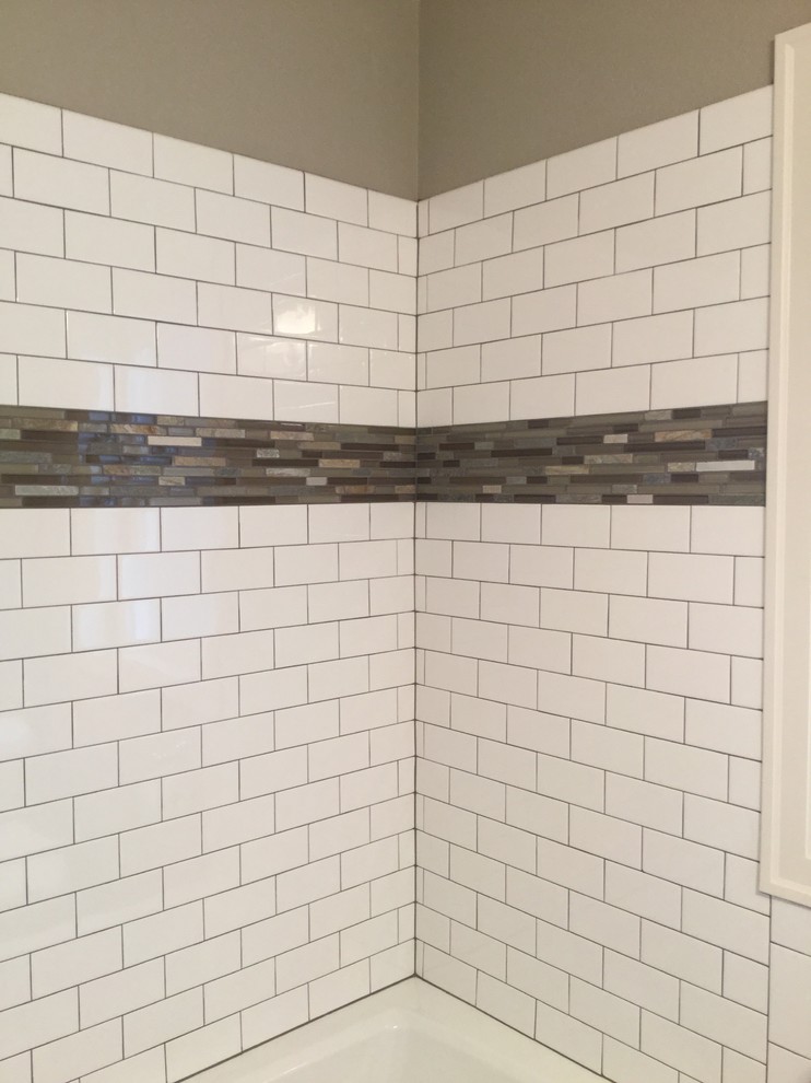 Photo of a small traditional 3/4 bathroom in Portland with flat-panel cabinets, white cabinets, an alcove tub, a shower/bathtub combo, a two-piece toilet, multi-coloured tile, subway tile, beige walls, slate floors and a pedestal sink.