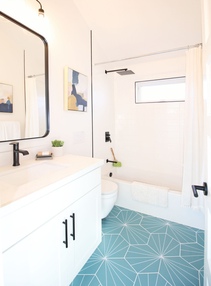 Inspiration for a small contemporary family bathroom in Seattle with flat-panel cabinets, white cabinets, an alcove bath, an alcove shower, a wall mounted toilet, white tiles, ceramic tiles, white walls, ceramic flooring, a submerged sink, quartz worktops, blue floors, a shower curtain, white worktops, a single sink and a built in vanity unit.