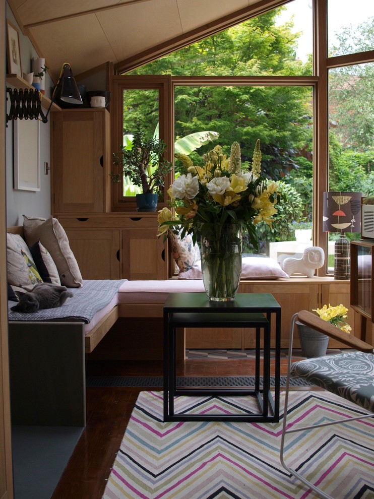 Photo of an eclectic sunroom in London.
