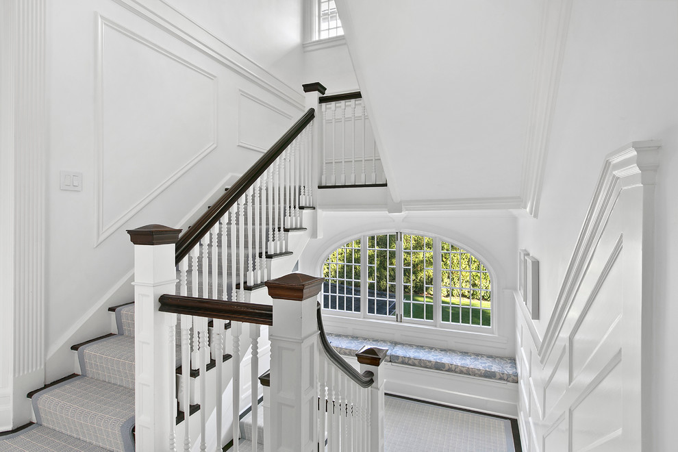 Design ideas for a traditional wood u-shaped staircase in New York with painted wood risers.