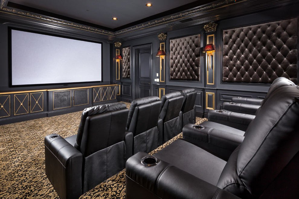 This is an example of a traditional enclosed home theatre in Los Angeles with black walls, carpet and a projector screen.