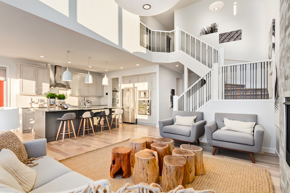 Living room - mid-sized contemporary formal and open concept light wood floor and beige floor living room idea in Calgary with white walls, a stone fireplace, no tv and a standard fireplace
