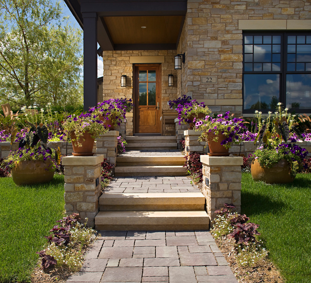 Mid-sized arts and crafts front yard partial sun formal garden in Orange County with a container garden and natural stone pavers for summer.
