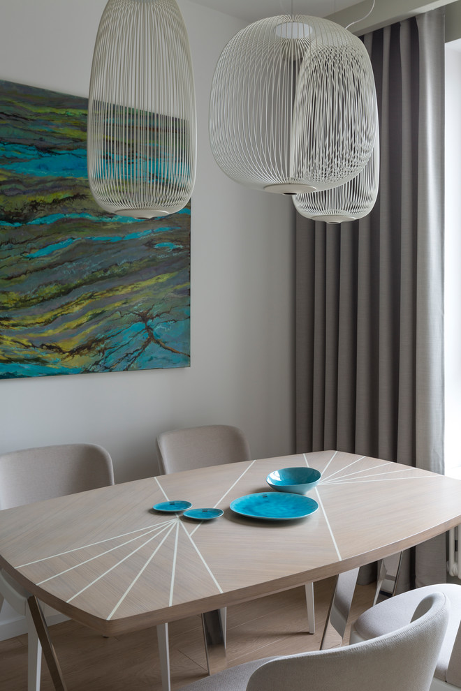 Photo of a contemporary open plan dining in Moscow with white walls, light hardwood floors and beige floor.