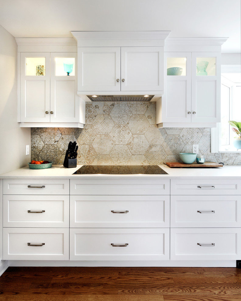 Inspiration for a large transitional l-shaped separate kitchen in Ottawa with an undermount sink, shaker cabinets, white cabinets, quartz benchtops, beige splashback, porcelain splashback, stainless steel appliances, light hardwood floors, with island, beige floor and white benchtop.