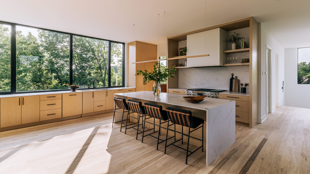 Inspiration for a large contemporary l-shaped kitchen in Minneapolis with an undermount sink, flat-panel cabinets, light wood cabinets, marble benchtops, red splashback, marble splashback, stainless steel appliances, light hardwood floors, with island, yellow floor and white benchtop.