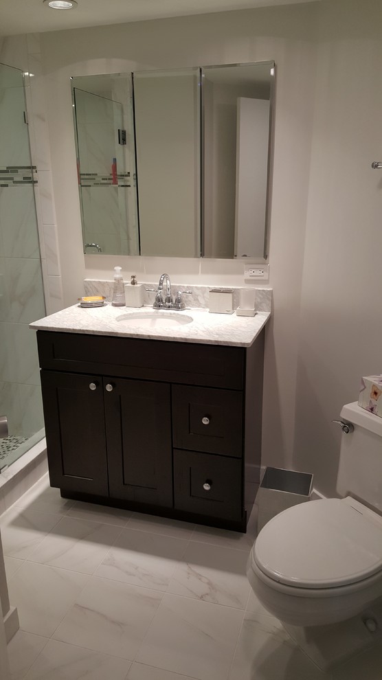 Photo of a small contemporary bathroom in Philadelphia with a vessel sink, shaker cabinets, dark wood cabinets, granite benchtops, an open shower, a two-piece toilet, white tile, stone slab, white walls and porcelain floors.