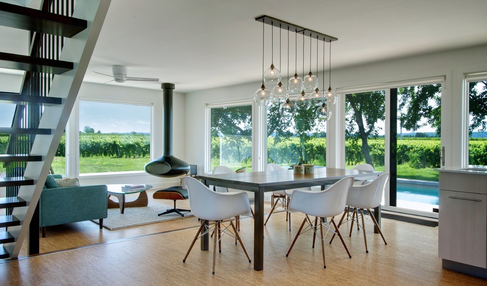 This is an example of a contemporary dining room in Toronto with light hardwood floors.