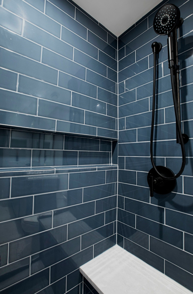 Mid-sized transitional master blue tile and porcelain tile concrete floor, beige floor and double-sink doorless shower photo in Chicago with raised-panel cabinets, blue cabinets, a two-piece toilet, blue walls, an undermount sink, quartzite countertops, a hinged shower door, white countertops and a built-in vanity