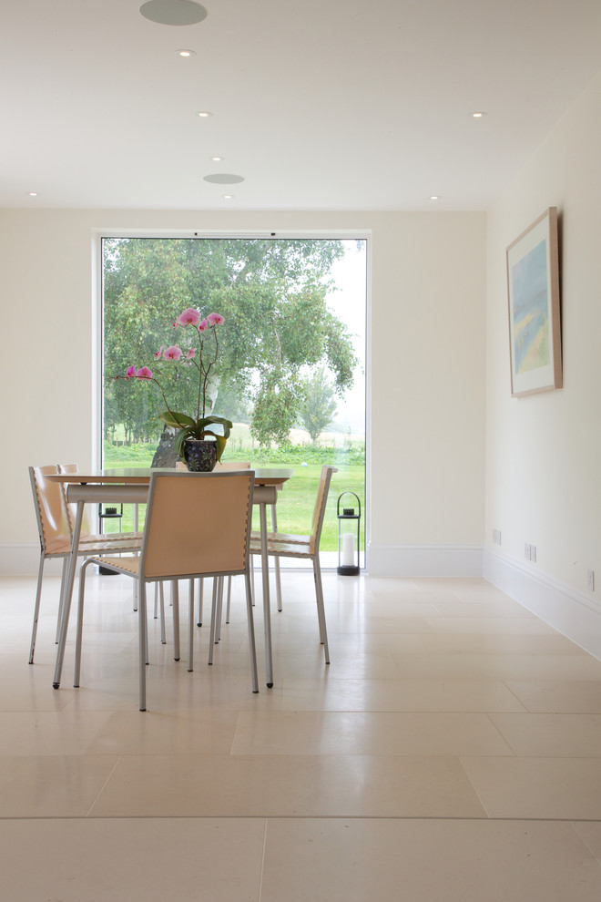 Contemporary dining room in Wiltshire with limestone floors.