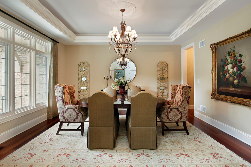 Design ideas for a traditional dining room in Denver with beige walls and dark hardwood floors.