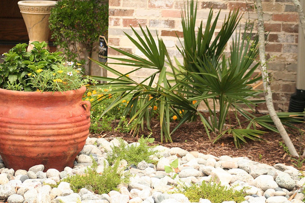 This is an example of a traditional front yard full sun xeriscape for summer in Dallas with brick pavers.