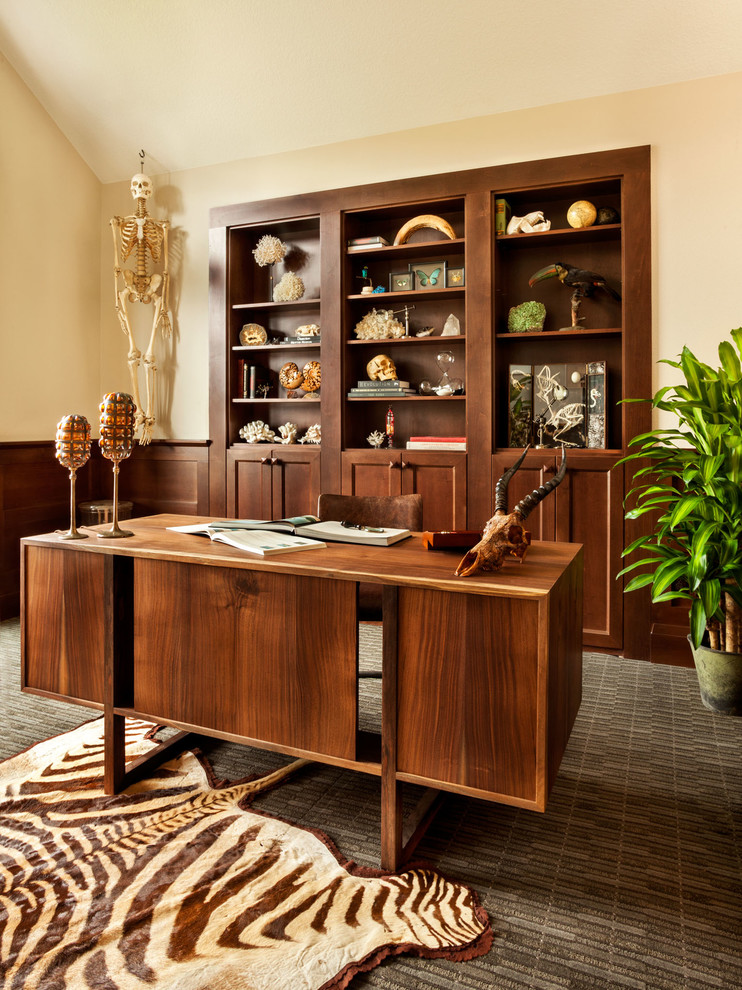 This is an example of a transitional home office in Portland with beige walls, carpet and a freestanding desk.