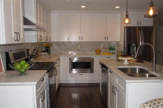 Transitional l-shaped dark wood floor eat-in kitchen photo in Boston with a double-bowl sink, shaker cabinets, white cabinets, marble countertops, gray backsplash, brick backsplash, stainless steel appliances and an island