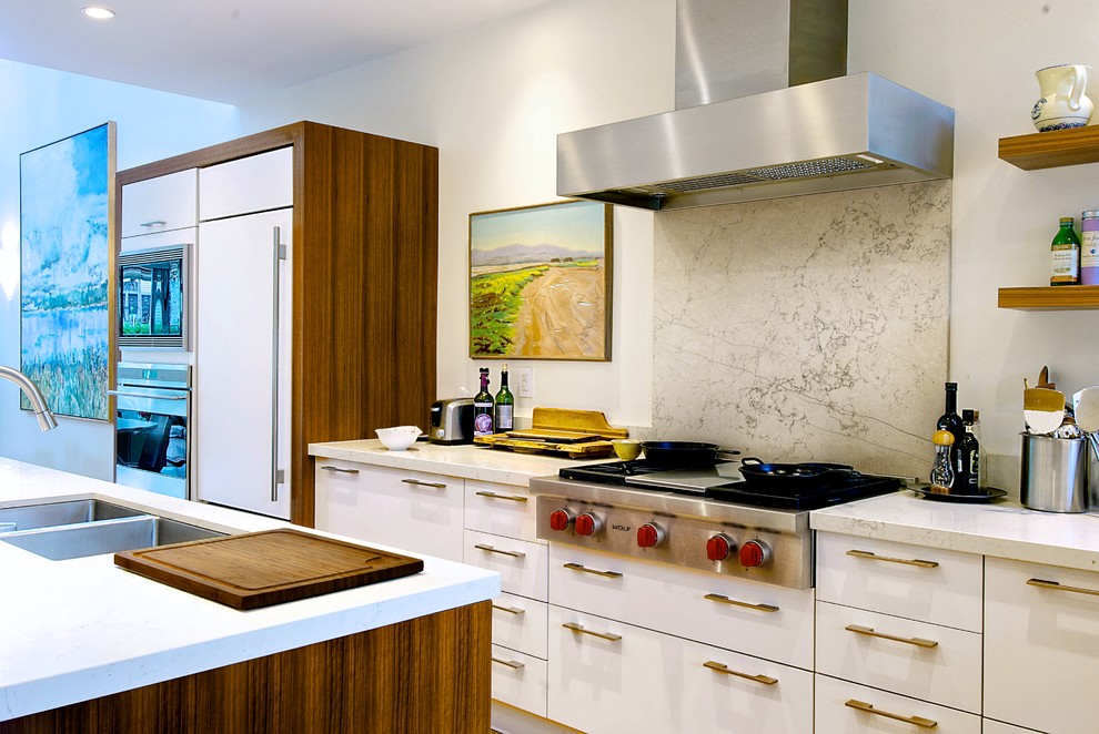 Inspiration for a modern galley kitchen in Toronto with a double-bowl sink, flat-panel cabinets, white cabinets, marble benchtops, white splashback, panelled appliances and marble splashback.