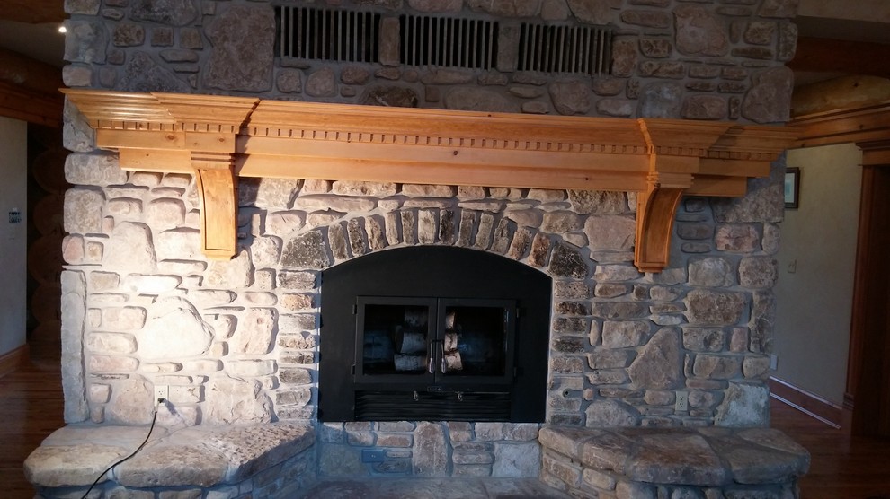 Example of a huge mountain style open concept medium tone wood floor home design design with a two-sided fireplace and a stone fireplace
