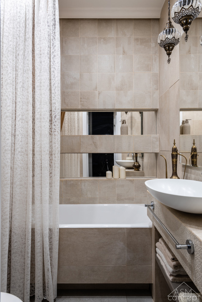 Design ideas for a mid-sized transitional master bathroom in Moscow with an undermount tub, a wall-mount toilet, beige tile, ceramic tile, beige walls, porcelain floors, a drop-in sink, tile benchtops, beige floor, beige benchtops, a single vanity and a built-in vanity.