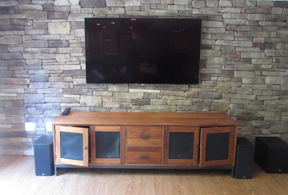 Inspiration for a large transitional walk-out vinyl floor basement remodel with beige walls, a standard fireplace and a stone fireplace