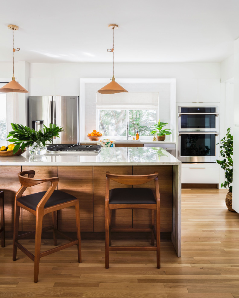 1960s u-shaped light wood floor and brown floor open concept kitchen photo in DC Metro with flat-panel cabinets, medium tone wood cabinets, quartzite countertops, white backsplash, subway tile backsplash, an island and gray countertops