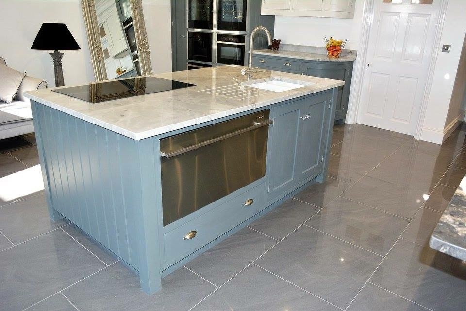 Inspiration for a large contemporary single-wall eat-in kitchen in Wiltshire with an undermount sink, recessed-panel cabinets, blue cabinets, marble benchtops, white splashback, marble splashback, stainless steel appliances, ceramic floors, multiple islands and grey floor.