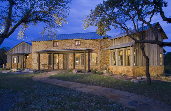 Mid-sized rustic brown two-story stone exterior home idea in Austin