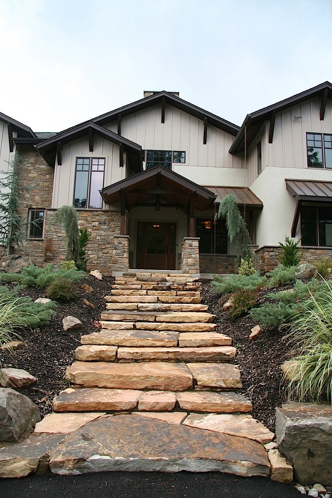 This is an example of a large traditional two-storey exterior in Philadelphia with stone veneer.