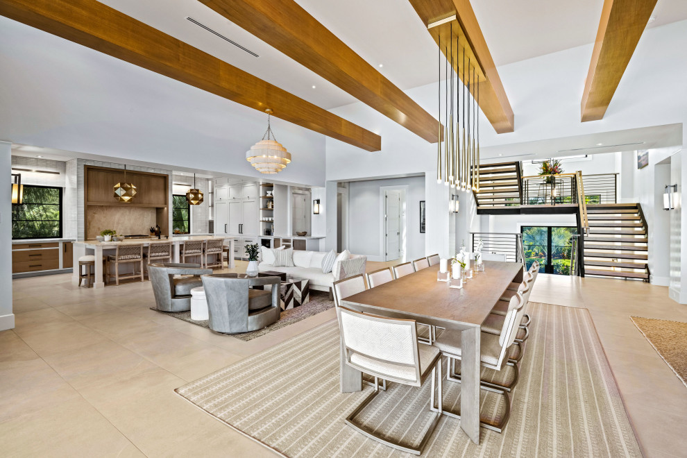 Photo of a large contemporary kitchen/dining room in Grand Rapids with white walls, ceramic flooring and beige floors.