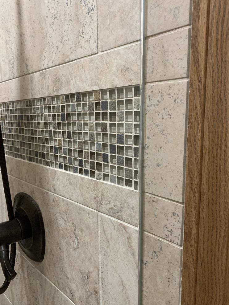 Large transitional master beige tile and ceramic tile linoleum floor and brown floor home design photo with recessed-panel cabinets, white cabinets, a two-piece toilet, beige walls, an undermount sink, granite countertops, a hinged shower door and multicolored countertops
