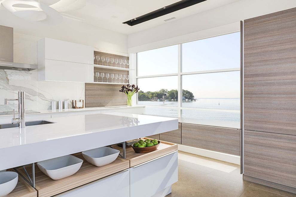 Inspiration for a large modern single-wall eat-in kitchen in New York with an integrated sink, flat-panel cabinets, white cabinets, quartz benchtops, white splashback, stone slab splashback, panelled appliances, porcelain floors and with island.